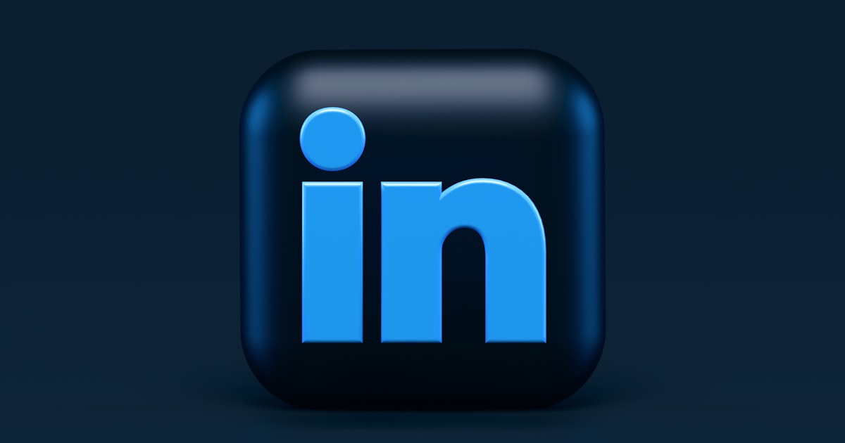 Professional reviewing their LinkedIn profile on a laptop